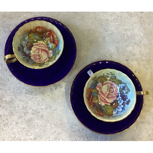 467 - A pair of Cobalt Blue Aynsley bone china teacups and saucers in Cabbage Rose pattern. Signed J A Bai... 