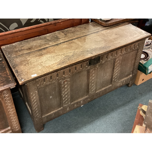 724 - A large oak four-panel coffer with hinged top. Est. £100 - £150.