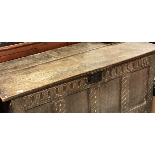 724 - A large oak four-panel coffer with hinged top. Est. £100 - £150.