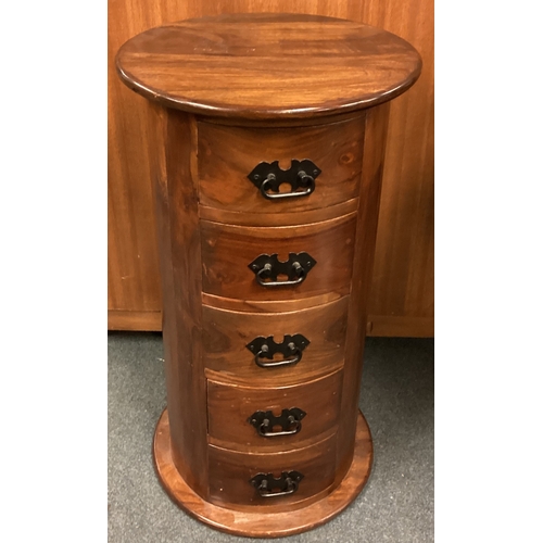 725 - An unusual cylindrical four-drawer bedside cabinet. Est. £30 - £50.