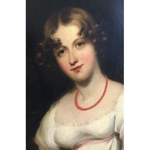 85 - WILLIAM OWEN: (Welsh, 1769- 1825): An oil on canvas depicting a portrait of a young lady seated in a... 