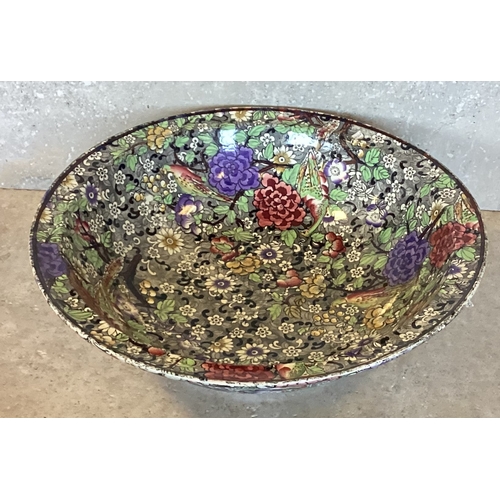 474 - A decorative ironstone bowl in bright colours. Est. £20 - £30.