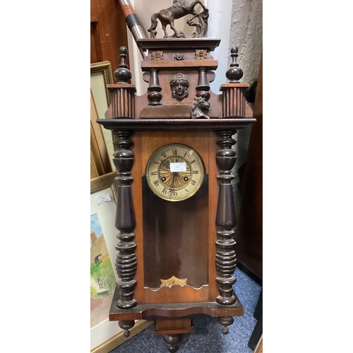 482 - A mahogany cased wall clock with carved decoration. Est. £20 - £30.