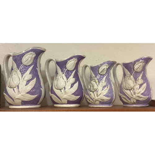 499 - A set of four ironstone jugs. Est. £20 - £30.