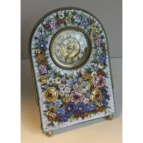 497A - A micro mosaic desk clock with floral decoration and winged infant to dial. Pen marked 'Boscowan E/R... 