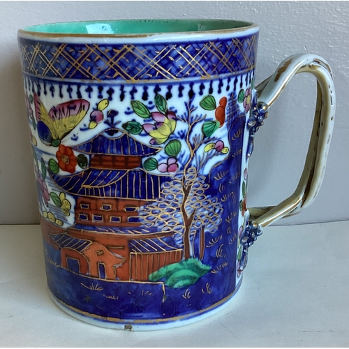 475A - A large Oriental style china tankard with decorative entwined handle. Inscribed to base. Approx. 13.... 