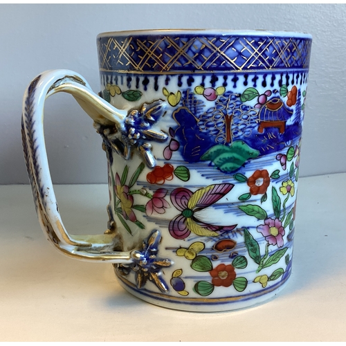 475A - A large Oriental style china tankard with decorative entwined handle. Inscribed to base. Approx. 13.... 