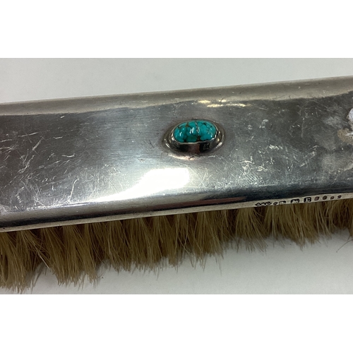 122 - LIBERTY & CO: A rare silver brush decorated with blue stone to centre. Approx. 88 grams of gross wei... 