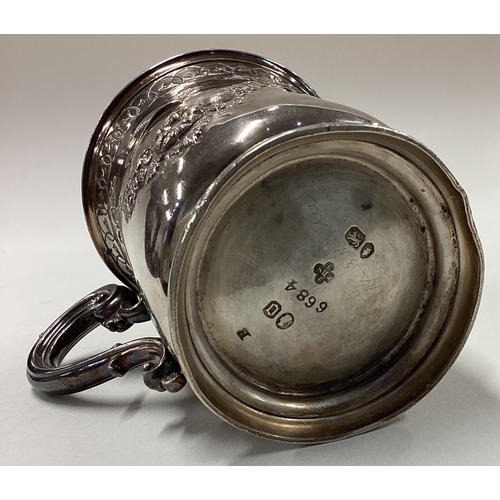 14 - A chased Victorian silver mug with embossed floral and bird decoration. By Barnards. Approx. 111 gra... 