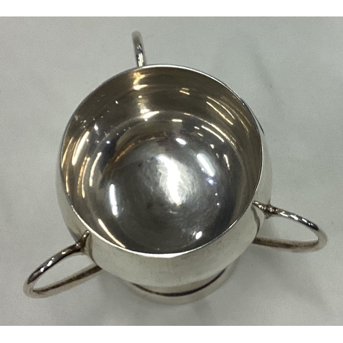 142 - A stylish silver three-handled tyg. London. Approx. 56 grams. Est. £30 - £50.