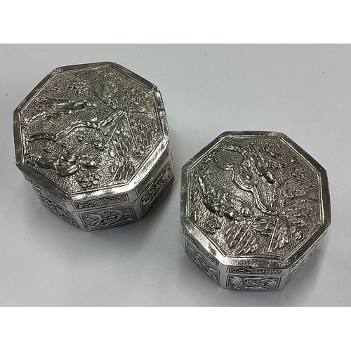 155 - A pair of Chinese export silver boxes embossed with scenes. Marked to bases. Approx. 87 grams. Est. ... 