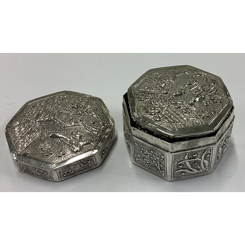 155 - A pair of Chinese export silver boxes embossed with scenes. Marked to bases. Approx. 87 grams. Est. ... 