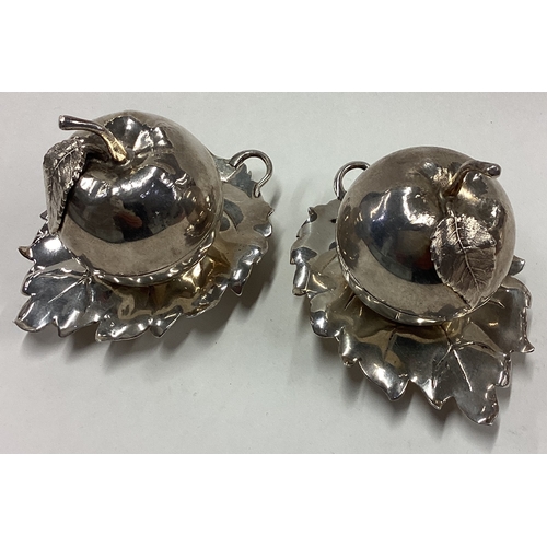 159 - A rare pair of silver salt and pepper condiments in the form of apples on leaf shaped stands. London... 