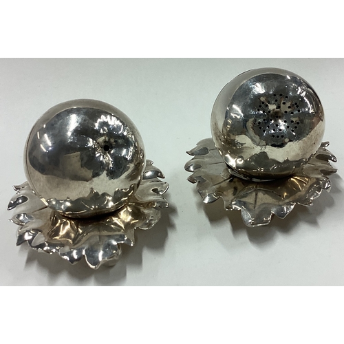 159 - A rare pair of silver salt and pepper condiments in the form of apples on leaf shaped stands. London... 