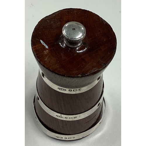 194 - A silver mounted and wood pepper grinder of barrelled form. Birmingham 1937. By Joseph Gloster & Son... 