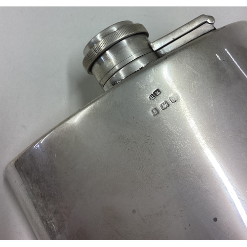 195 - A silver flask of curved form. Birmingham 1923. By Henry Mathews. Approx. 191 grams. Est. £300 - £40... 