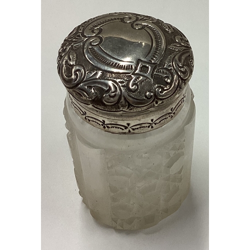 20 - An embossed Victorian silver perfume bottle with hinged lid. London 1901. Est. £50 - £80.