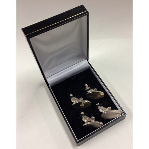 202 - A boxed set of four silver plated menu holders in the form of birds. Est. £40 - £60.