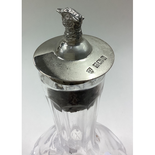 203 - A silver and glass liqueur bottle cast with pheasant to lid. Birmingham 1988. Est. £30 - £40.