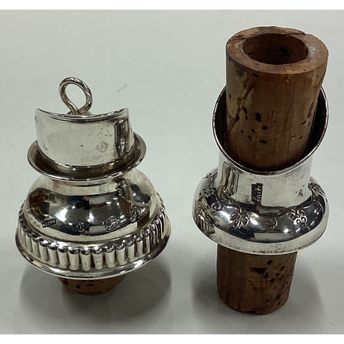 24 - Two good silver mounted wine bottle stoppers. Approx. 54 grams of gross weight. Approx. £30 - £50.