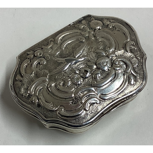 249 - An 18th Century George II silver snuff box with hinged lid embossed with birds and flowers. Maker's ... 