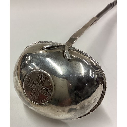 275 - A large 19th Century silver toddy ladle with coin inset to centre. Approx. 51 grams. Est. £50 - £80.