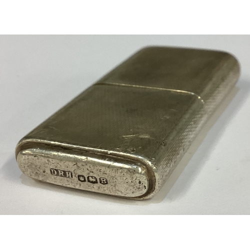 298 - An Art Deco silver lighter with engine turned decoration. Marked to base. Approx. 67 grams. Est. £10... 