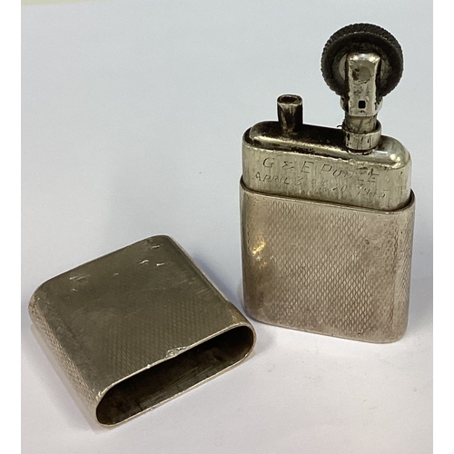 298 - An Art Deco silver lighter with engine turned decoration. Marked to base. Approx. 67 grams. Est. £10... 