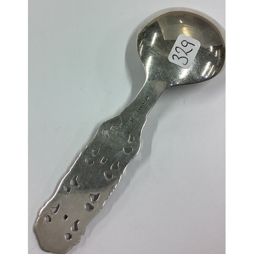 329 - A Continental silver caddy spoon with pierced handle. Approx. 22 grams. Est. £20 - £30.