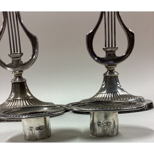 335 - A rare pair of silver candlesticks with lyre decoration. Sheffield 1912. By Fordham & Faulkner. Appr... 