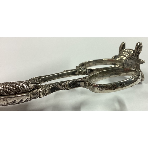 337 - A novelty pair of silver ice tongs in the form of a stork with concealed baby inside standing on a t... 