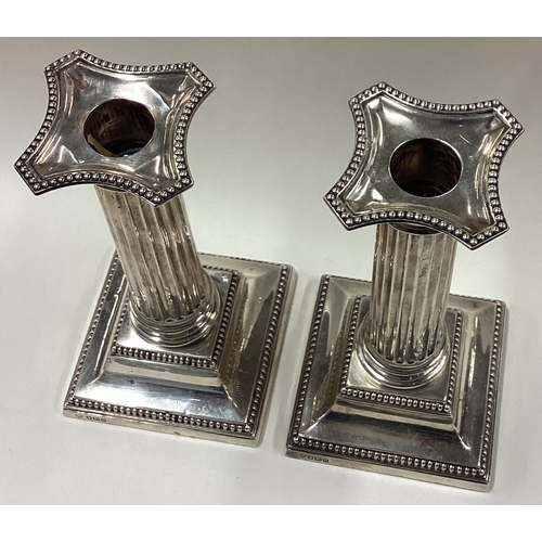 345 - A large pair of silver Corinthian candlesticks. Sheffield 1914. By Hawksworth Eyre & Co Ltd. Approx.... 