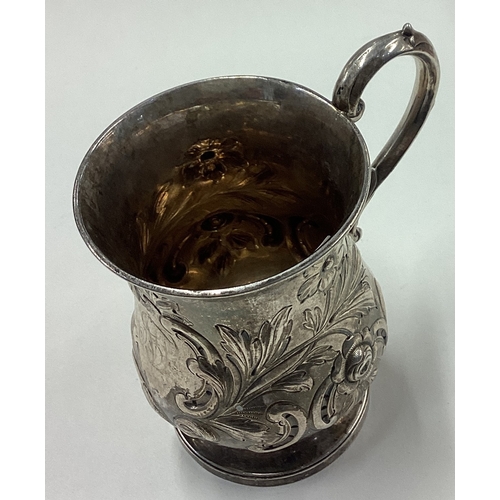 35 - A Victorian silver christening mug chased with floral decoration. Birmingham 1848. Approx. 106 grams... 