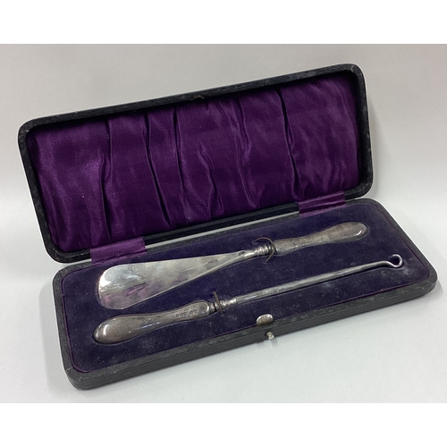 357 - A silver shoe horn set. Birmingham. Est. £80 - £120.