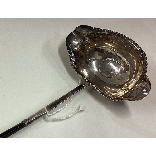 388 - A large 19th Century silver and whalebone toddy ladle inset with coin to centre. Circa 1800. Approx.... 