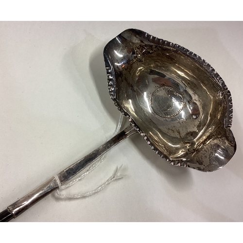 388 - A large 19th Century silver and whalebone toddy ladle inset with coin to centre. Circa 1800. Approx.... 