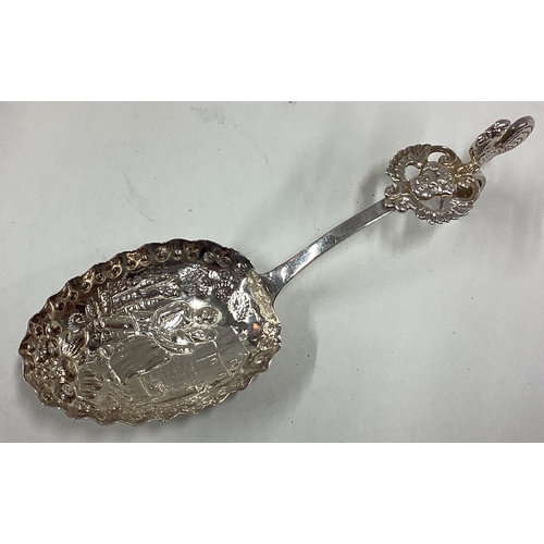 389 - A 19th Century Dutch silver caddy spoon with chased decoration. Approx. 20 grams. Est. £30 - £40.