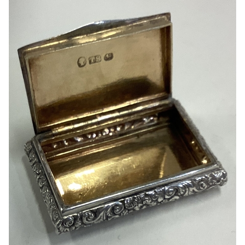 402 - A good silver snuff box with chased decoration to hinged lid. Birmingham. By TS. Approx. 40 grams. E... 