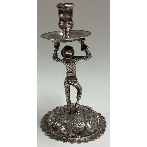 417 - An Antique silver figural taperstick in the form of a harlequin. Approx. 101 grams. Est. £300 - £400... 