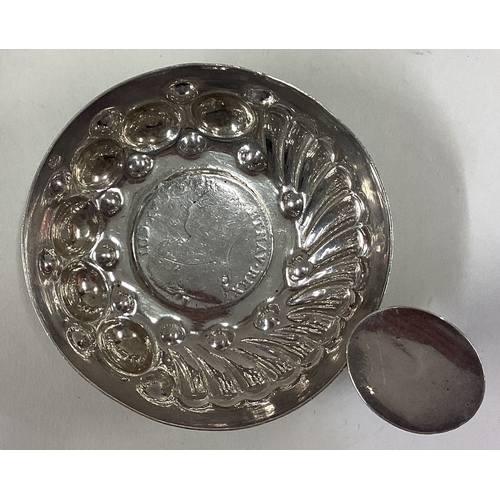 423 - An Antique French silver wine taster inset with coin to centre. Approx. 60 grams. Est. £80 - £120.