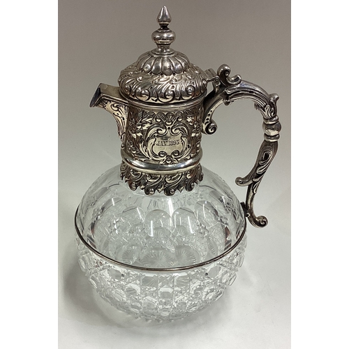 438 - A Victorian silver claret jug with embossed decoration. London 1890. By CE/JL. Est. £300 - £400.