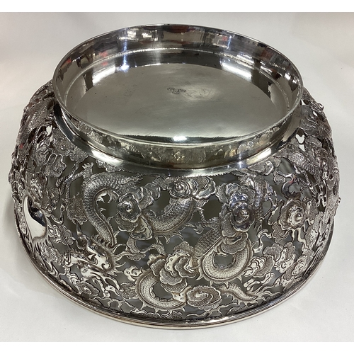 490 - WANG HING: A large and fine 19th Century Chinese export silver bowl pierced with dragon and floral d... 