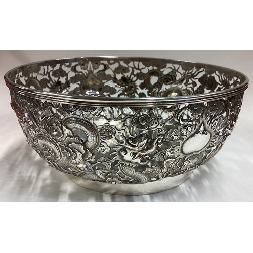 490 - WANG HING: A large and fine 19th Century Chinese export silver bowl pierced with dragon and floral d... 