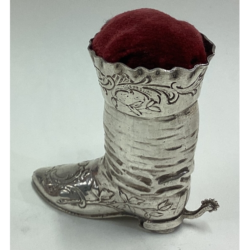 525 - A 19th Century German silver pin cushion in the form of a cowboy boot. Marked to base. Approx. 41 gr... 