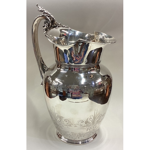 538 - A large and impressive American silver water jug with engraved decoration and Naturalistic handle. M... 