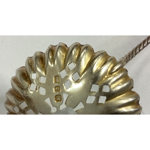 562 - A good silver gilt Apostle top sifter spoon. Birmingham. Approx. 7 grams. Est. £20 - £30.