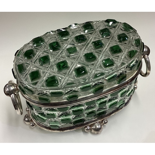 583 - A silver plated and glass biscuit box. Est. £50 - £80.