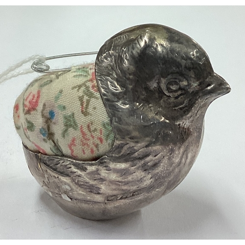 589 - A silver pin cushion in the form of a chick bearing import marks. Approx. 35 grams. Est. £50 - £80.