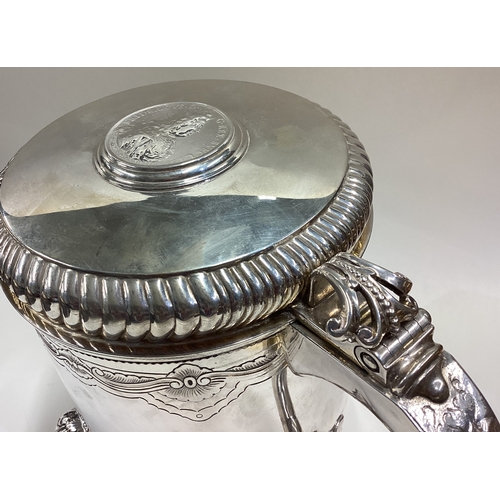 593 - A 19th Century Continental silver flagon with coin inset to cover and Naturalistic ball feet in the ... 