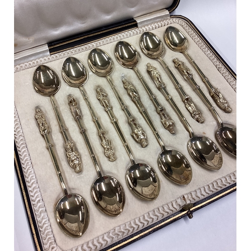 600 - A good set of twelve silver gilt Apostle top spoons with bamboo design to terminals contained within... 